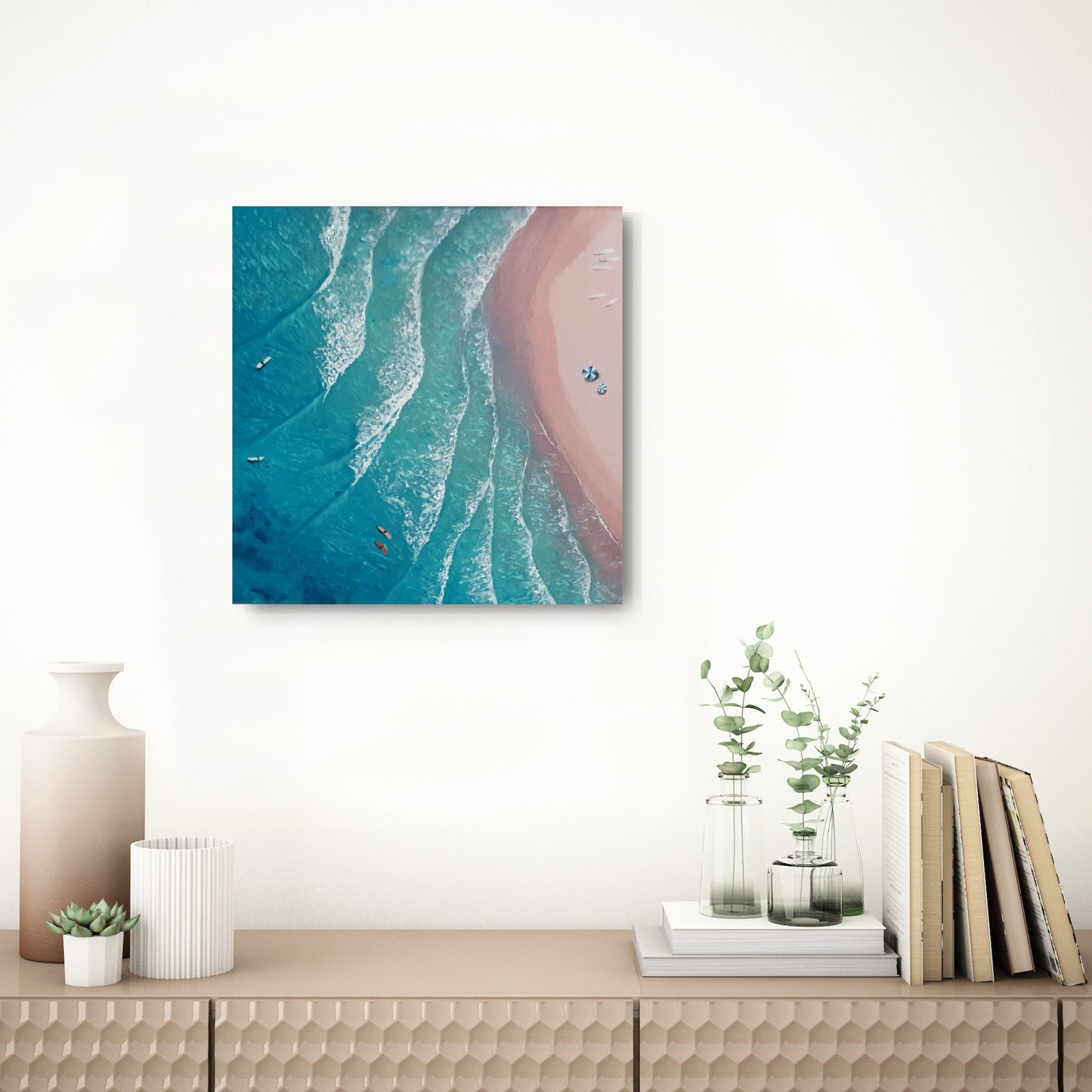 Surfers Paradise- An aerial view painting of pink sand beach and turquoise water hanging over an elegant wood table with a vase