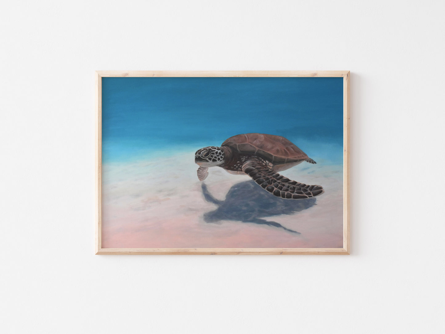 Large sea turtle painting on canvas in soft blue and blush tones, framed in natural wood