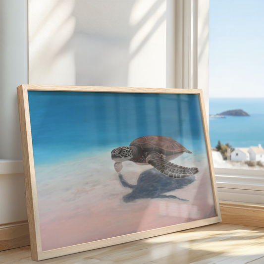Large sea turtle painting on canvas in soft blue and blush tones, framed in natural wood, leaning against a window with ocean view
