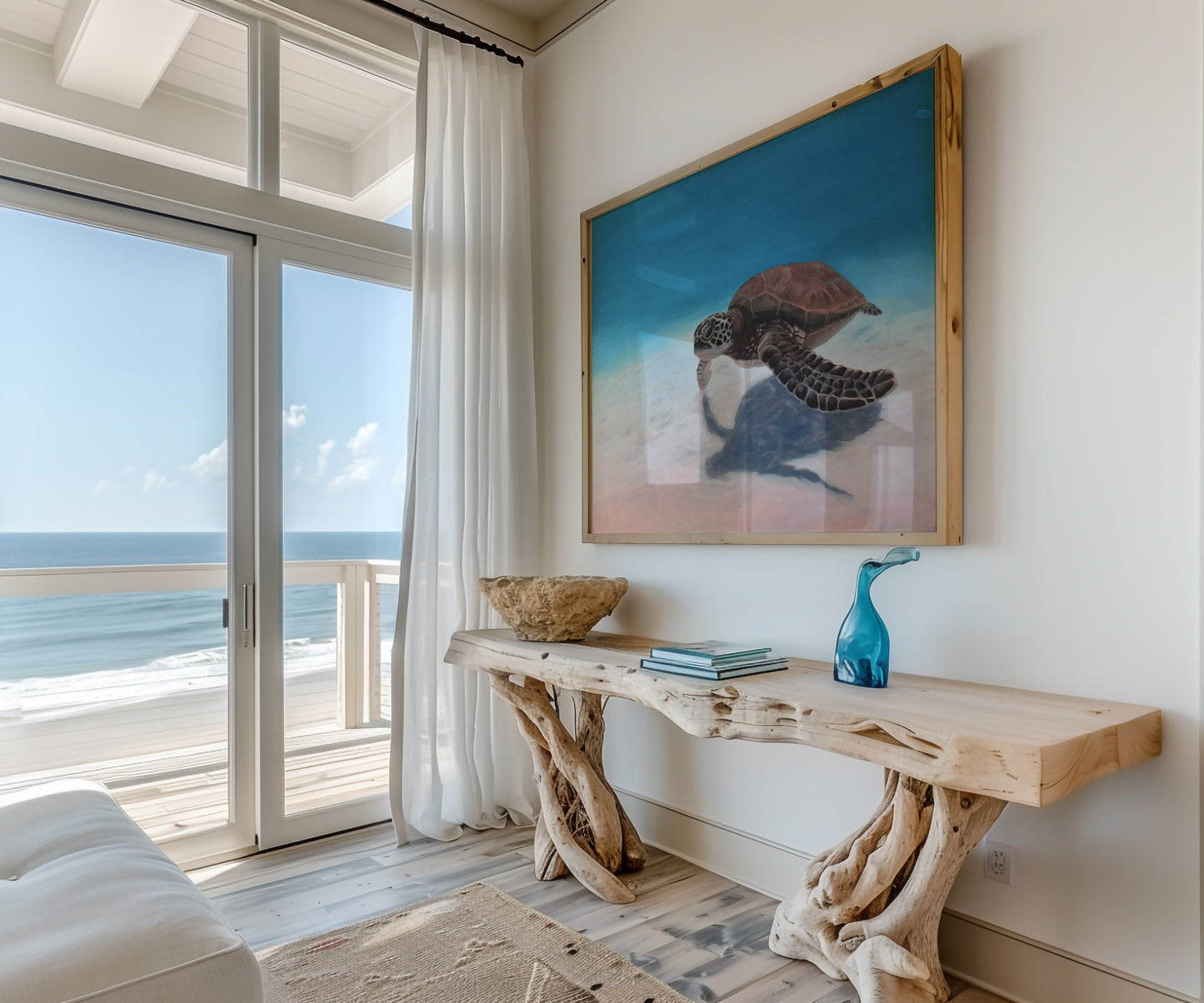Large sea turtle painting on canvas in soft blue and blush tones, framed in natural wood, hanging in a beach house.