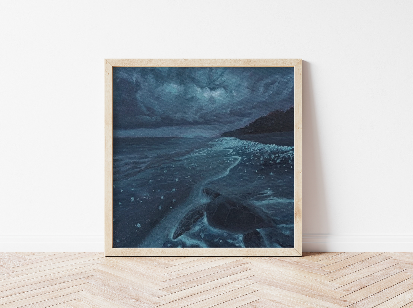 Dark blue ocean painting on canvas showing a sea turtle on a moonlit beach, framed in natural wood