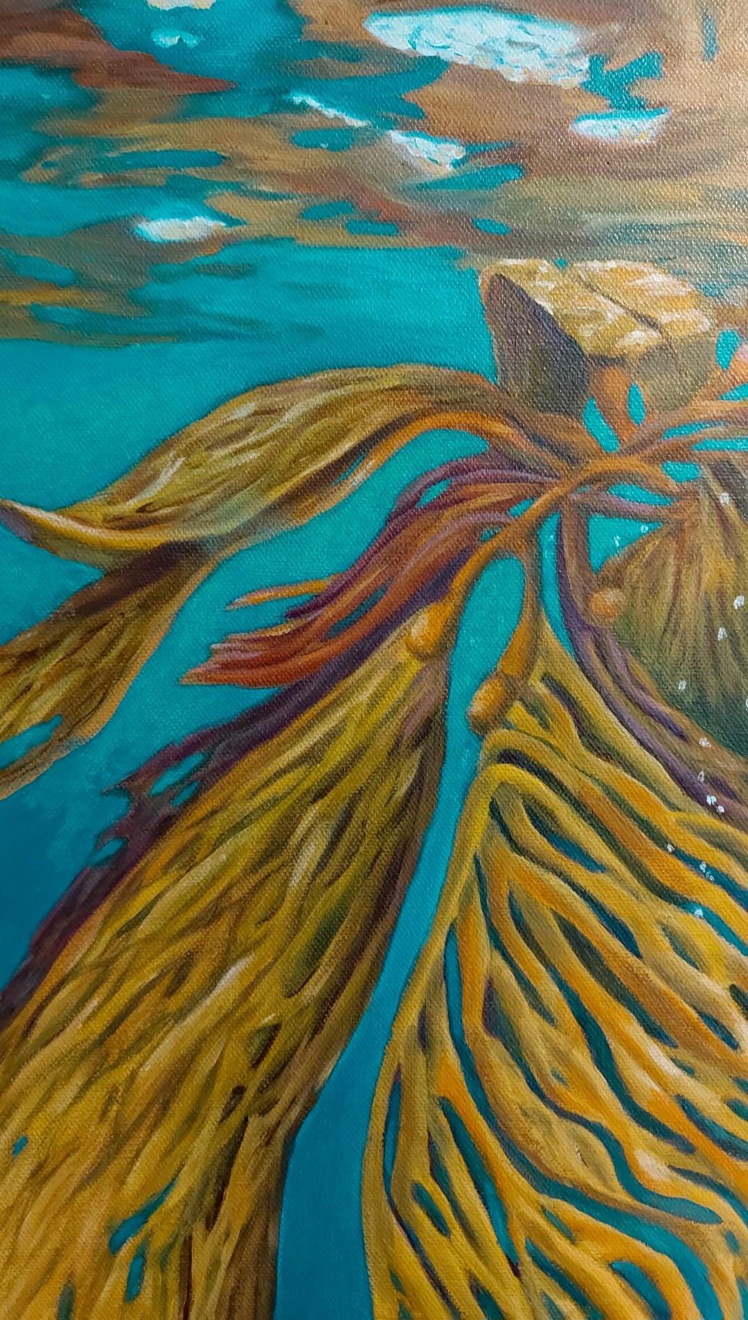 Recover is an oil painting on canvas by Katherine Polack of a mustard coloured sea kelp in a brightly coloured turquoise emerald water. It's reflection can be seen on the surface on the top 1/3 of the painting. Recover symbolizes the resilience and strength that we all have within us and was inspired by the documentary My Octopus Teacher. Find the many hidden hearts in the painting. 18 x 24" oil on canvas